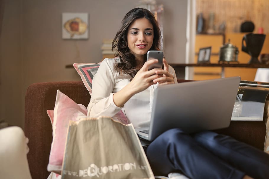 woman-mobile-laptop-shopping-ecommerce-smile